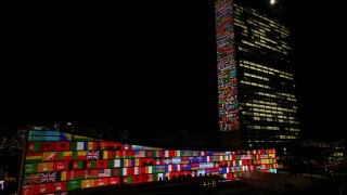 Big scale projections are seen over the general assembly building at United Nations headquarters on September 22, 2015 in New York City.