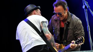 Bruce Springsteen performs on stage with Brian Fallon of The Gaslight Anthem