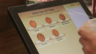 Wawa pizza options seen on a touchscreen.