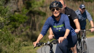 First lady Jill Biden rides her bike with President Joe Biden on a trail at Gordon's Pond in Rehoboth Beach, Del., Sept. 19, 2021.