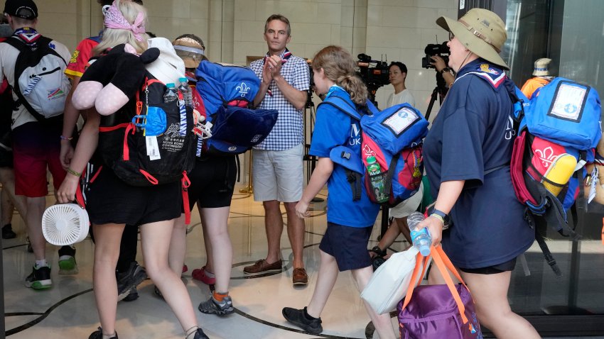 Gareth Weir, center, British Deputy Ambassador to South Korea, greets scout members of his country as they arrive from the World Scout Jamboree campsite at a hotel, South Korea, Saturday, Aug. 5, 2023. South Korea is plowing ahead with the World Scout Jamboree, rejecting a call by the world scouting body to cut the event short as a punishing heat wave caused thousands of British and U.S. scouts to begin leaving the coastal campsite Saturday.