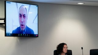 Commissioner Allen Dickerson, appears on a screen, while speaking during a Federal Election Commission public meeting on whether it should regulate the use of AI-generated political campaign advertisements, Thursday, Aug. 10, 2023, in Washington.