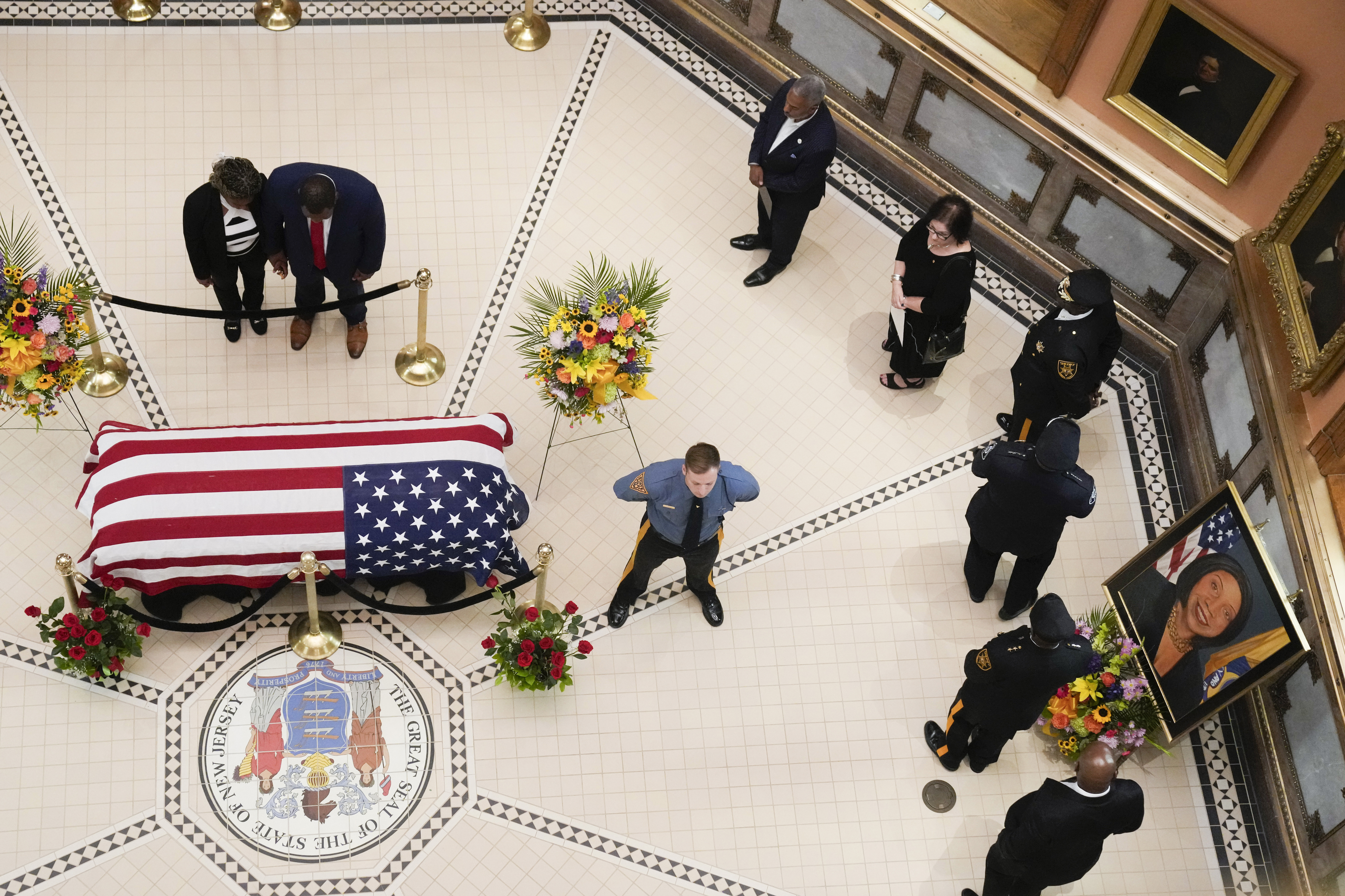 People pass by a portrait of New Jersey Lt. Gov. Sheila Oliver as they line up to pay respect while she lies in state in the statehouse's rotunda in Trenton, N.J., Thursday, Aug. 10, 2023. Oliver died earlier this month after a short hospital stay for an undisclosed illness.