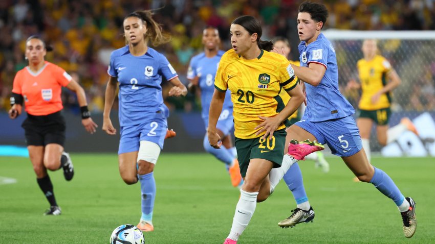 Australia’s Sam Kerr, centre, challenges for the ball with France’s Elisa De Almeida, right, and France’s Maelle Lakrar during the Women’s World Cup quarterfinal soccer match between Australia and France in Brisbane, Australia, Saturday, Aug. 12, 2023.