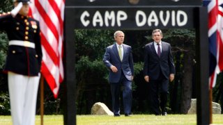 President George W. Bush, left, and British Prime Minister Gordon Brown walk to a joint press availability at Camp David, Md.