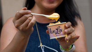 Van Leeuwen's new Kraft mac and cheese flavor ice cream melts due to the high temperatures at a popup truck near Union Square on July 14, 2021 in New York City.