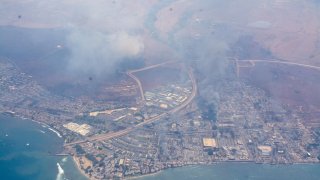 Smoke billows over Lahaina in this undated photo released by the County of Maui on Aug. 10, 2023. The historic town of Lahaina was reduced to ashes by Thursday, aerial photos show.