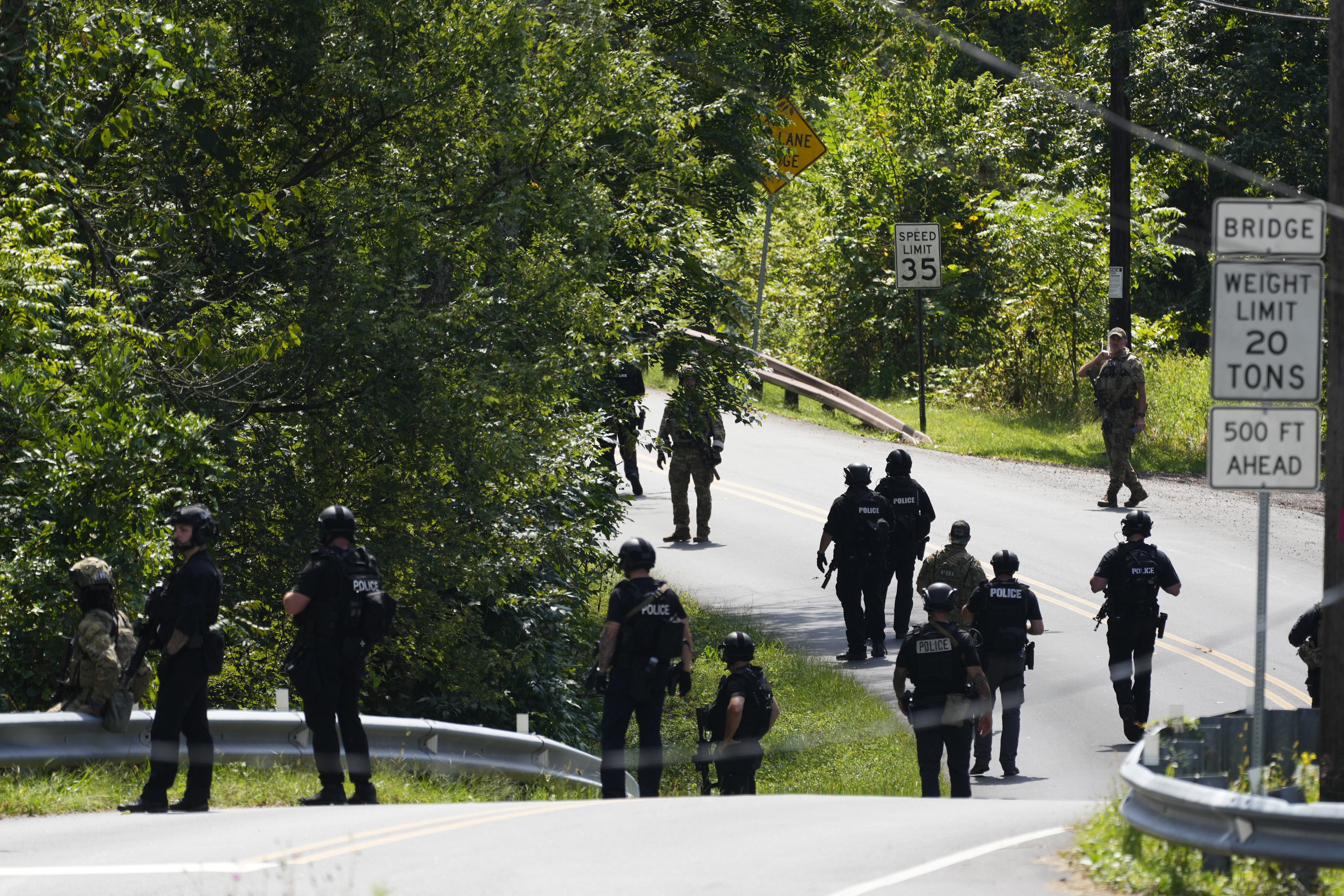 Law enforcement officers gather as the search for escaped convict Danelo Cavalcante continues Tuesday, Sept. 12, 2023, in Pottstown, Pa. (AP Photo/Matt Rourke)