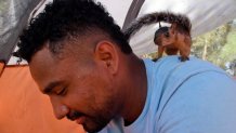 In this image taken from video, Niko, a pet squirrel, stands on the shoulder of Yeison in their tent at a migrant camp on Wednesday, Sept. 20, 2023 in Matamoros, Mexico.