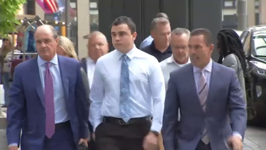 Former Philadelphia Police Officer Mark Dial, center in blue, enters court for a bail hearing on Tuesday, Sept. 19, 2023.