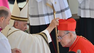 Italian archbishop Agostino Marchetto (R) is elevated cardinal by Pope Francis during a consistory to create 21 new cardinals at St. Peter’s square in The Vatican on September 30, 2023.