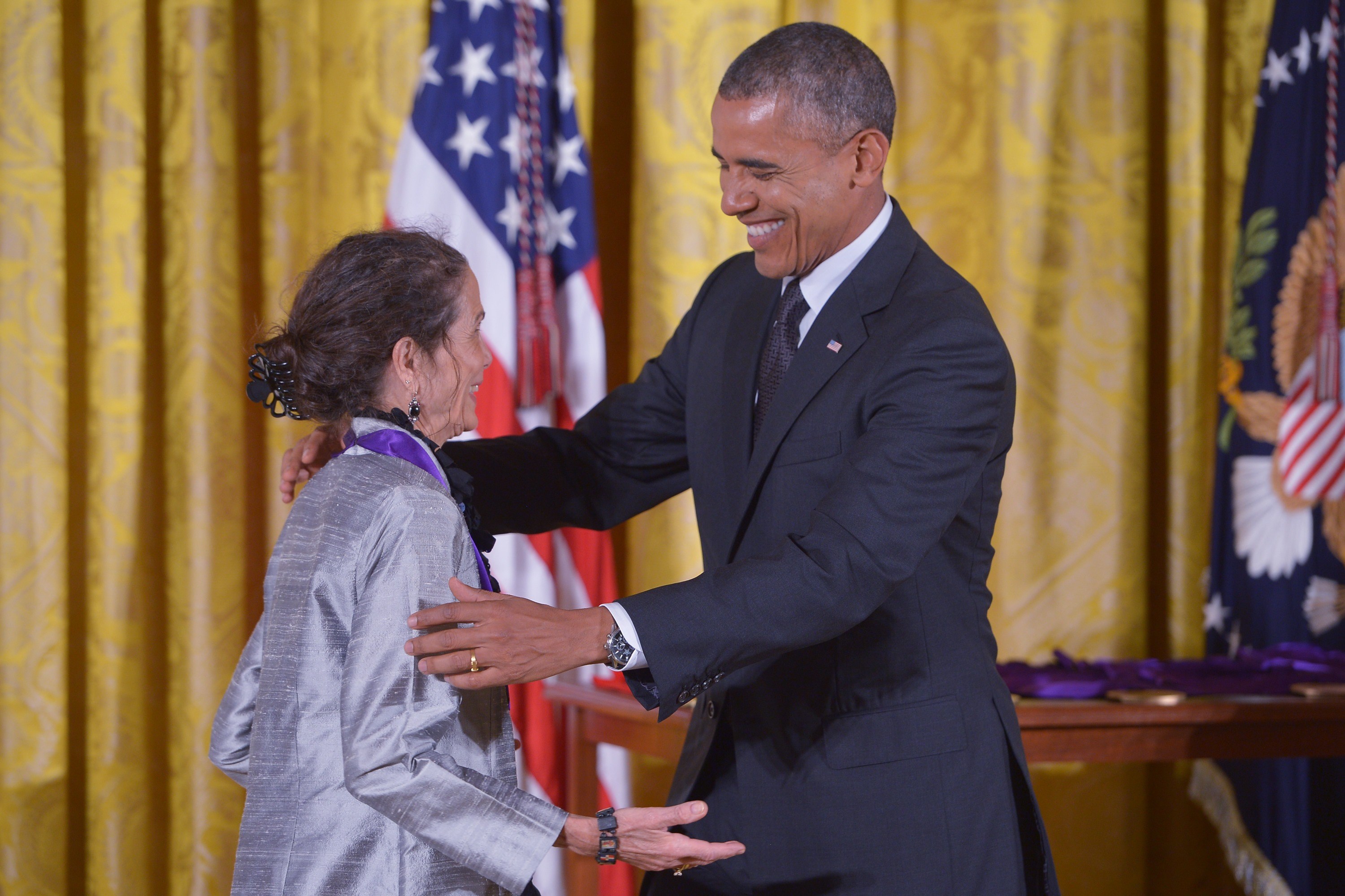 US President Barack Obama presents the National Medal of Arts to Julia Alvarez, novelist, poet, and essayist, during a ceremony in the East Room of the White House on July 28, 2014 in Washington, DC. AFP PHOTO/Mandel NGAN        (Photo credit should read MANDEL NGAN/AFP via Getty Images)