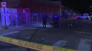 Police officers investigate after a man was killed at Broad and Chew streets in Philadelphia's Fern Rock neighborhood late Saturday.