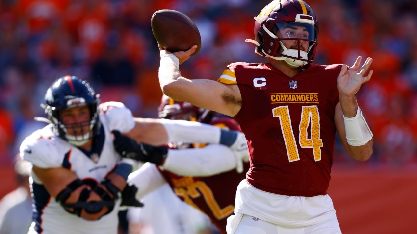 Sam Howell attempts a pass during the second quarter against the Denver Broncos.