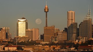 The full moon, otherwise known as a strawberry supermoon, is seen over the Skyline of the CBD in Sydney, Australia June 15, 2022.