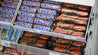 Snickers and Mars candy bars, produced by Mars Inc., sit on display.