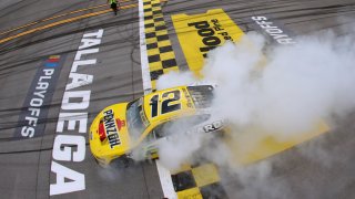 Ryan Blaney, driver of the No. 12 Menards/Pennzoil Ford, celebrates with a burnout after winning the NASCAR Cup Series YellaWood 500 at Talladega Superspeedway on Oct. 1, 2023 in Talladega, Ala.