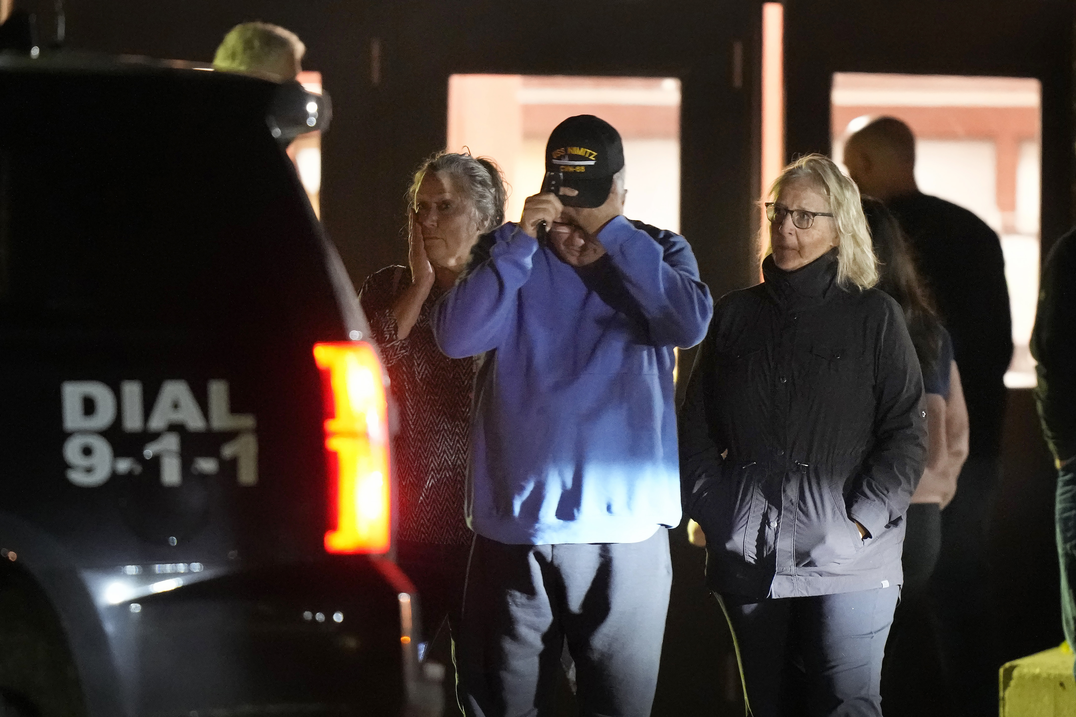 People depart a reunification center early Thursday, Oct. 26 at Auburn Middle School, in Auburn, Maine, after shootings in Lewiston.