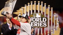 St. Louis Cardinals manager Tony LaRussa holds up the championship trophy after a 6-2 win over the Texas Rangers in Game 7 of the World Series at Busch Stadium in St. Louis, Missouri, on Friday, October 28, 2011. (Ron Jenkins/Fort Worth Star-Telegram/Tribune News Service via Getty Images)