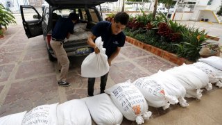 Shopkeepers take precautions by protecting store entrances with sandbags in Puerto Vallarta, Jalisco State, Mexico, on October 10, 2023.