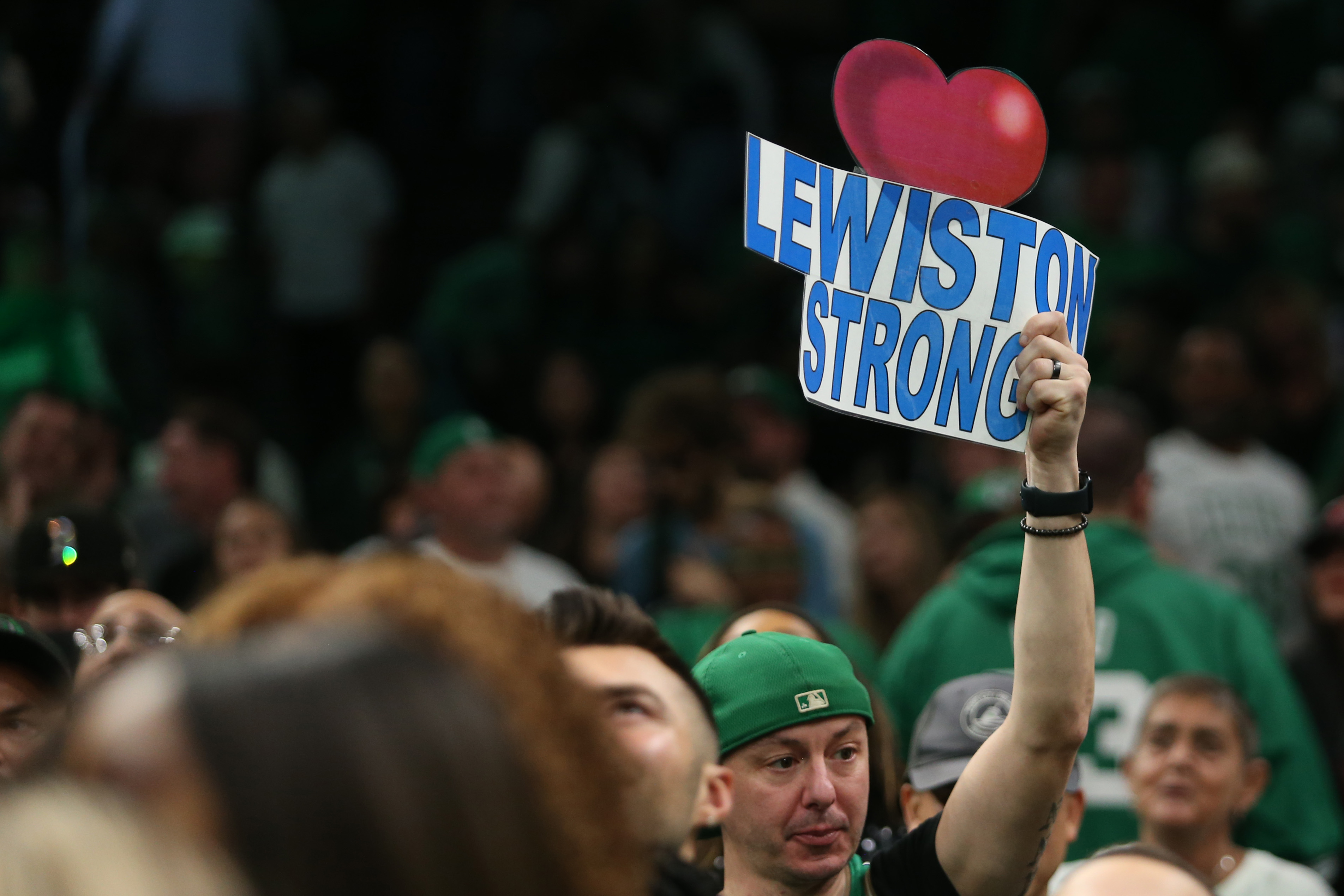 BOSTON, MASSACHUSETTS – OCTOBER 27: A fan holds a “Lewiston Strong” sign after the game between the Boston Celtics and the Miami Heat at TD Garden on October 27, 2023 in Boston, Massachusetts. A man gunned down 18 people with a semi-automatic rifle in a bowling alley and a bar where locals were enjoying an evening out on October 25 2023 in Lewiston, Maine. NOTE TO USER: User expressly acknowledges and agrees that, by downloading and or using this photograph, User is consenting to the terms and conditions of the Getty Images License Agreement. (Photo by Maddie Schroeder/Getty Images)