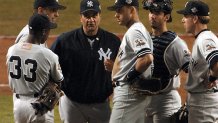 PHOENIX, UNITED STATES:  New York Yankees Manager Joe Torre (3rd R) stands on the mound with the Yankees infield players during a pitching change in Game 6 of the World Series against the Arizona Diamondbacks in Phoenix 03 November 2001. AFP PHOTO/Mike NELSON (Photo credit should read MIKE NELSON/AFP via Getty Images)