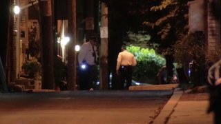Police officers investigate after a man was shot in a robbery attempt in Center City Philadelphia on Sunday night.