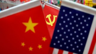 The flags of China, U.S. and the Chinese Communist Party are displayed in a flag stall at the Yiwu Wholesale Market in Yiwu, Zhejiang province, China, May 10, 2019.