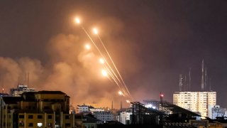 A salvo of rockets is fired by Palestinian militants from Gaza City toward Israel, on October 8, 2023.