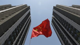 A Chinese flag flies outside a residential compound in Beijing on April 30, 2017.