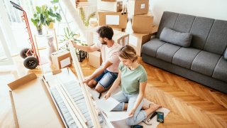 A couple assembling furniture.