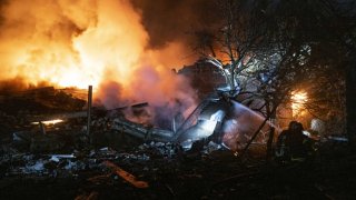 Firefighters try to extinguish a fire at a destroyed building after Russian shelling at night, in the center of the Pokrovsk, Ukraine, on Nov. 30, 2023.