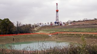 In this Oct. 29, 2008 photo, a drilling rig used to extract natural gas from the Marcellus Shale, located on a hill above a pond on John Dunn's farm in the Washington County borough of Houston, Pa.