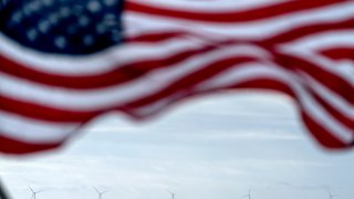 The five turbines of America's first offshore wind farm, owned by the Danish company, Orsted, are seen from a tour boat flying the American flag off the coast of Block Island, R.I., Oct. 17, 2022.