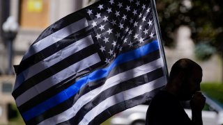 In this Aug. 30, 2020 file photo, an unidentified man participates in a Blue Lives Matter rally in Kenosha, Wis.