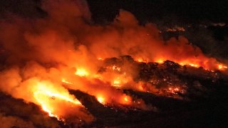 FILE – Fire consumes an area next to the Transpantaneira road in the Pantanal wetlands near Pocone, Mato Grosso state, Brazil, on Nov. 15, 2023.