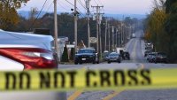 Police tape blocks off the street near Schemengees Bar and Grille in Lewiston, Maine, on October 27, 2023, in the aftermath of a mass shooting. Hundreds of police in the US state of Maine hunted October 26, 2023 for a fugitive gunman who killed 18 people at a bowling alley and a bar, as President Joe Biden mourned “yet another senseless and tragic mass shooting.” Police named the suspect as 40-year-old Robert Card — seen in surveillance footage pointing a semi-automatic rifle as he walked into the Sparetime Recreation bowling alley. (Photo by ANGELA WEISS / AFP) (Photo by ANGELA WEISS/AFP via Getty Images)