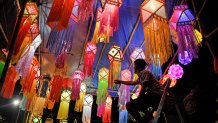 A shopkeeper arranges lanterns for sale in advance