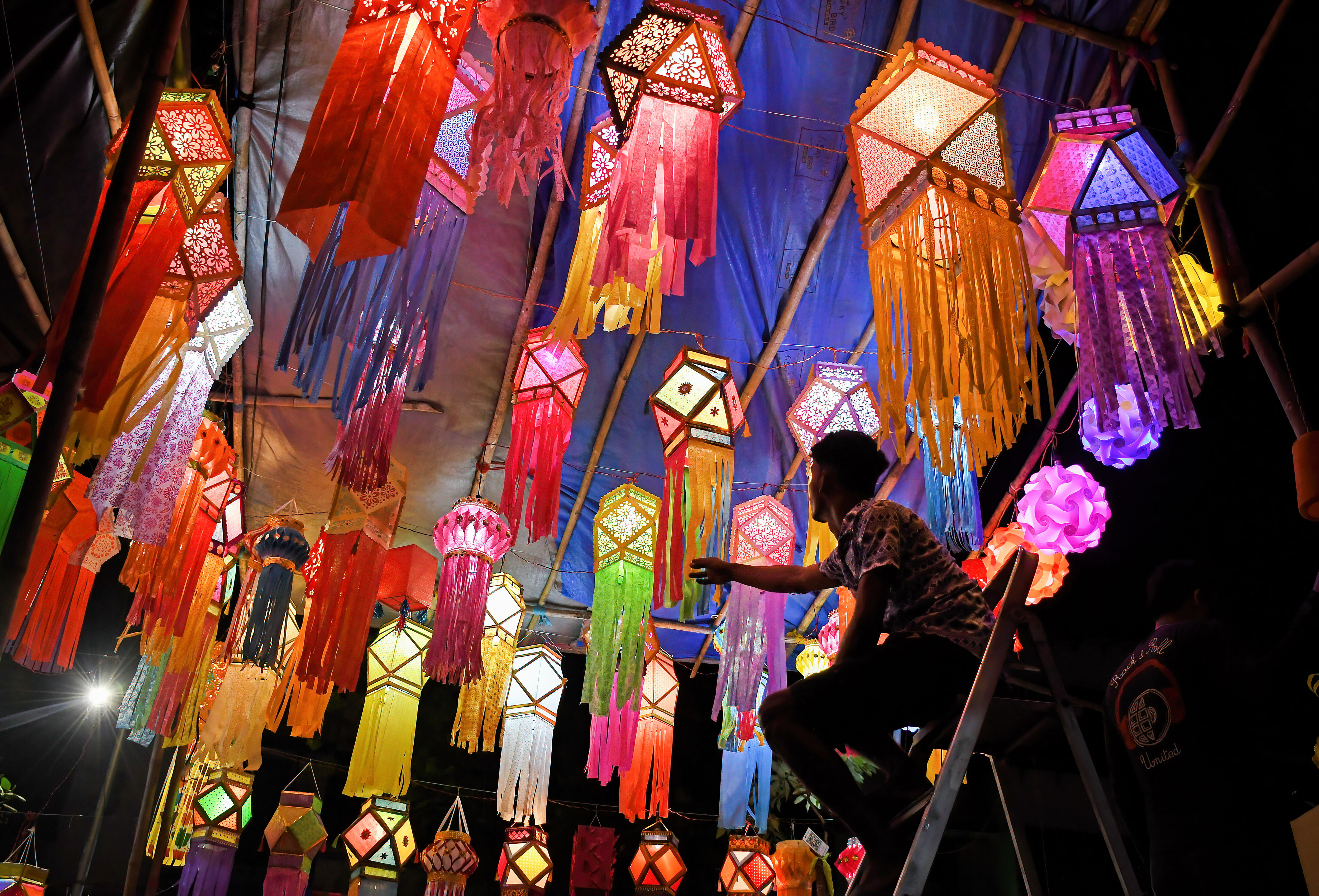 A shopkeeper arranges lanterns kept for sale ahead of the