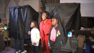 Cherelle Parker, the Democratic candidate for mayor of Philadelphia, exits the voting booth with her son and godson in tow, on Tuesday morning.