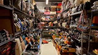 A storage unit full of counterfeit goods including wallets and bags.