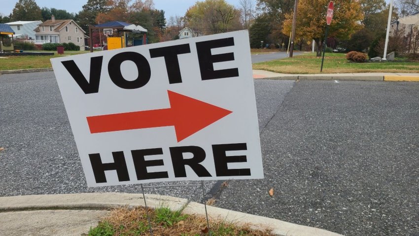 "Vote Here" sign with an arrow