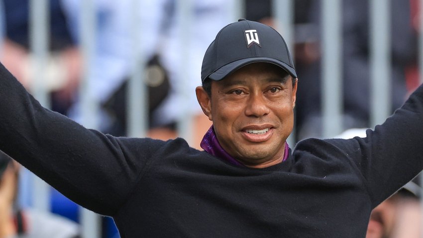 Tiger Woods stretching with a golf club