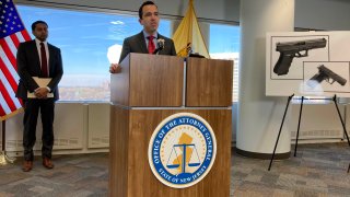 New Jersey Attorney General Matt Platkin, at the lectern, unveils lawsuits against three companies he said violated the state’s firearms laws, at his office on Tuesday, Dec. 12, 2023, in Trenton, N.J. The suits were the first brought by his office under a 2022 law aimed at holding gun dealers accountable by allowing the attorney general to sue under New Jersey’s public nuisance laws. (AP Photo/Mike Catalini)