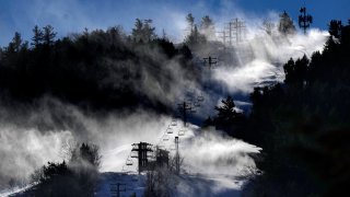 Man-made snow is blown from snowmaking equipment near the summit of Pleasant Mountain ski resort.