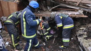 Rescuers operate on a building following Russian strikes, in Zmiiv, Kharkiv region, on January 8, 2024, amid the Russian invasion of Ukraine. At least three people have been killed and dozens injured in a fresh wave of Russian strikes across Ukraine, regional officials said on January 8, 2024. In the eastern region of Kharkiv, an elderly woman who was pulled from the rubble of her house in the city of Zmiiv died, regional governor Oleg Synegubov said. (Photo by SERGEY BOBOK / AFP) (Photo by SERGEY BOBOK/AFP via Getty Images)