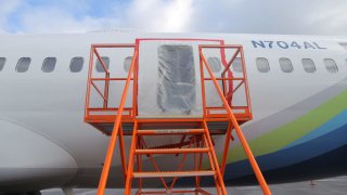 The fuselage plug area of Alaska Airlines Flight 1282 Boeing 737-9 MAX, which was forced to make an emergency landing with a gap in the fuselage, is seen during its investigation by the National Transportation Safety Board (NTSB) in Portland, Oregon, U.S. January 7, 2024.