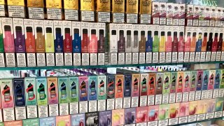 Vape flavours for sale on display in shop window, Essex, England. 