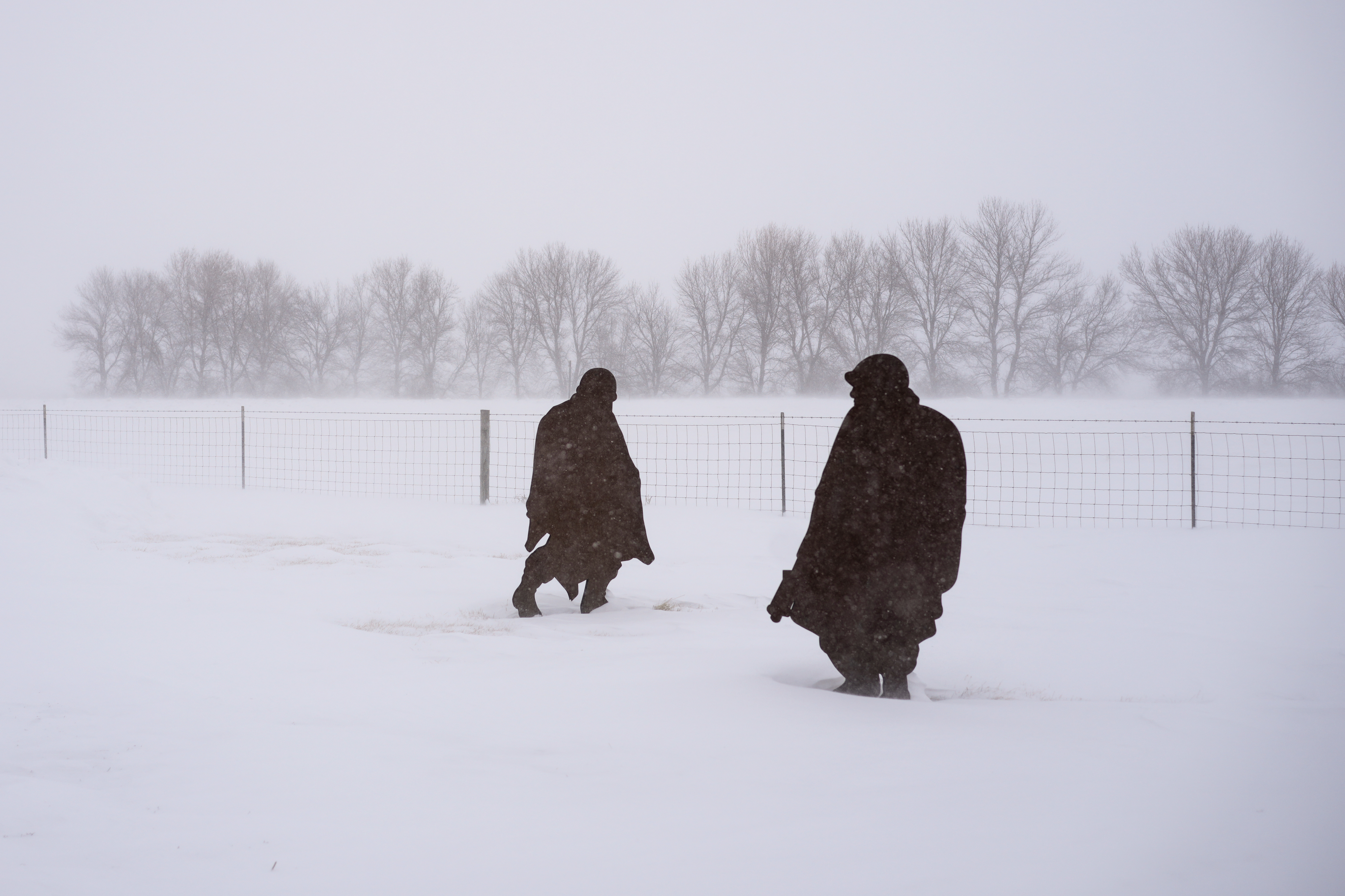 Sculptures of Korean War soldiers are seen in the blowing snow in Salix, Iowa, during a winter storm, Friday, Jan. 12, 2024.