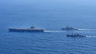 The three countries conducted combined naval exercises involving the American aircraft carrier in their latest show of strength against nuclear-armed North Korea.